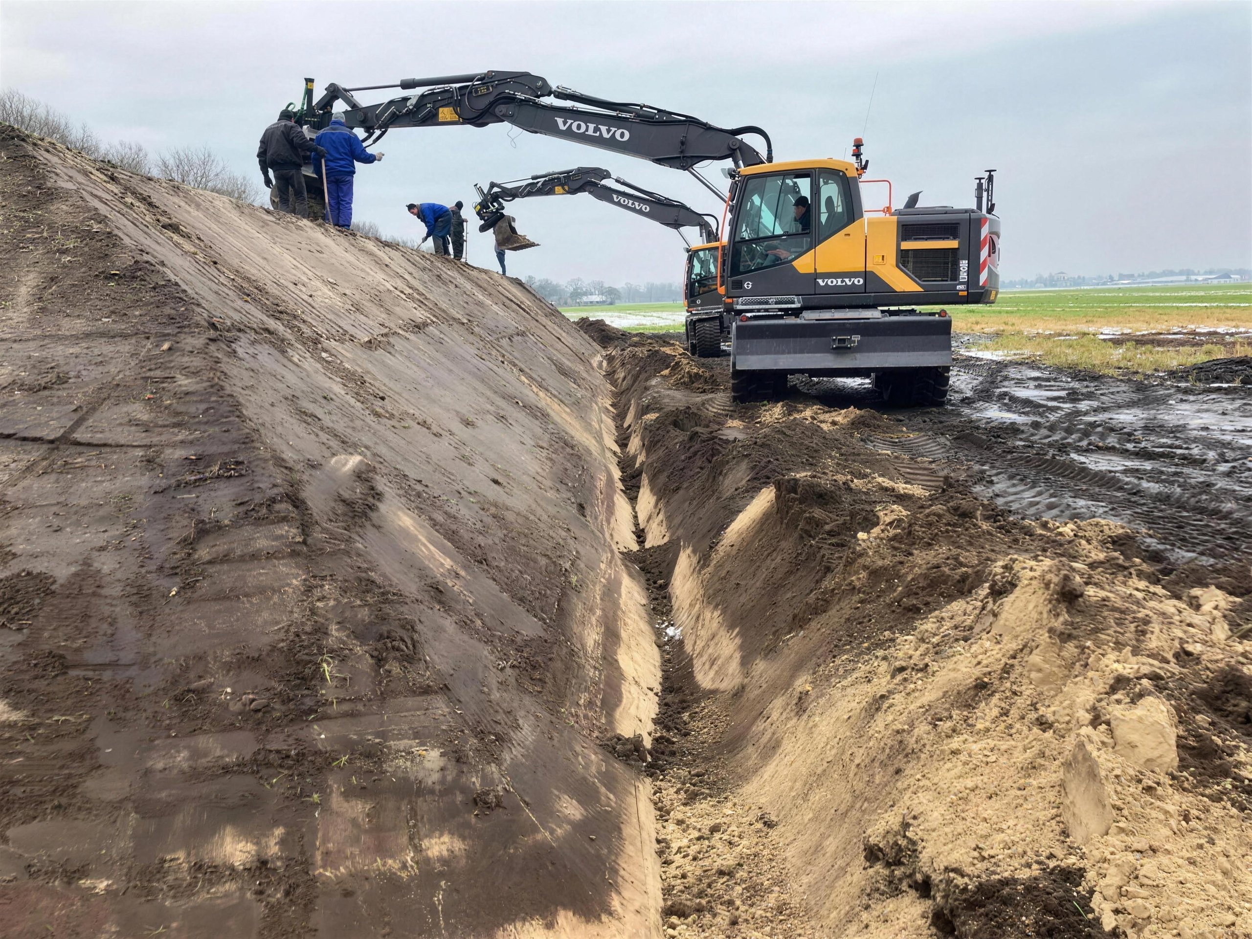 Volvo EW 160 graaft een sleuf in een talud